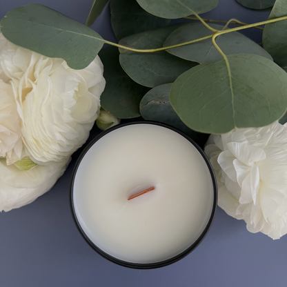 Close-up of inside a Buko pandan candle surrounded by ranuncula flowers and eucalyptus